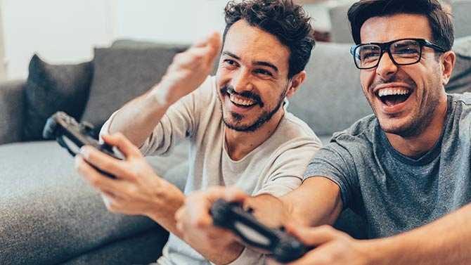 2 men playing video game 