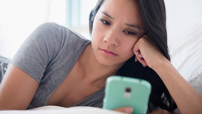 a women on the phone while in bed