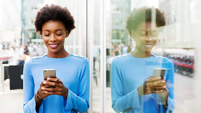 A woman holding a smartphone. Understanding smartphone security tips is essential.